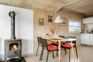 a kitchen with a table and a wood stove at 1319-Thisted-Store-Knuds-Vej-9 in Thisted