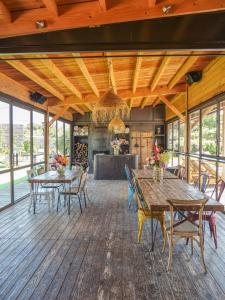a dining room with tables and chairs on a wooden floor at Lodges en Provence - Ecogîtes & Restaurant insolites in Richerenches
