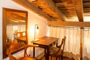 a room with a table and chairs and a mirror at Maison De Charme Avec Jacuzzi in Arcangues