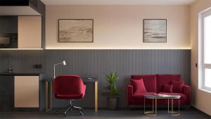 a living room with a red couch and a table at PLAZA Residence Mannheim in Mannheim