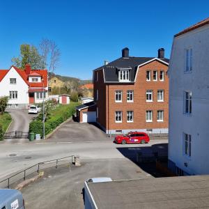 a red car parked in front of a building at Hotell S:t Olof in Falköping