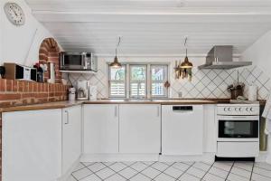 a kitchen with white cabinets and a counter top at R624-Rodvig-Stevns-Strandvaenget-6 in Rødvig