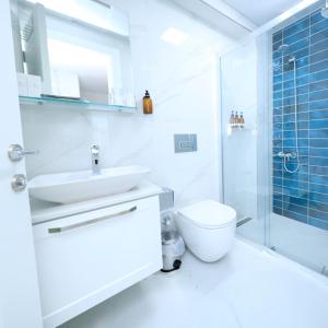 a bathroom with a toilet and a sink and a shower at Felicitta Stay & Joy in Seferihisar +12 photos