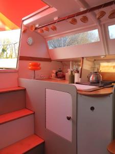 an interior view of a kitchen in a rv at Bateau Gîte in Berné