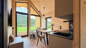 a kitchen and dining room of a tiny house at Apartment Bergsee in Lunz am See