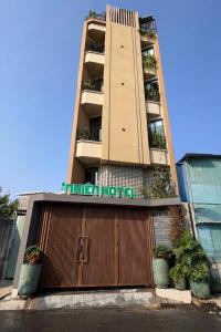 a building with a gate in front of a building at Nhiên Hotel in Ho Chi Minh City
