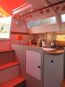 an interior view of a kitchen in a rv at Bateau Gîte in Berné