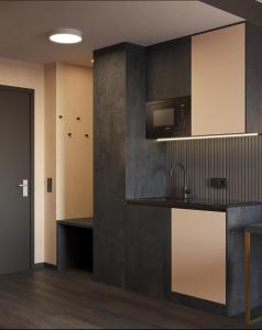 a kitchen with a sink and a microwave at PLAZA Residence Mannheim in Mannheim