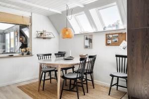 a dining room with a table and chairs at 1335-Vestervig-Spovevej-11 in Vestervig +13 photos