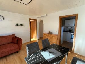 a living room with a table and a couch at Ferienwohnung Wieser in Sankt Jakob in Haus