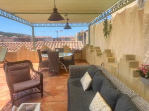 a living room with a couch and chairs and a table at Casa Sultana in Propriano
