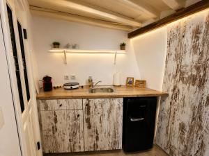 a small kitchen with a sink and a counter at Litharaki Guest House in Ano Syros