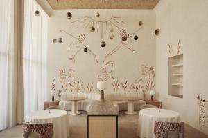 a living room with a drawing on the wall at Insotel Fenicia Prestige Suites & Spa in Santa Eularia des Riu