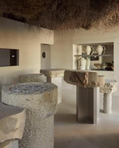 a room with a table and some rocks at Insotel Fenicia Prestige Suites & Spa in Santa Eularia des Riu +95 photos