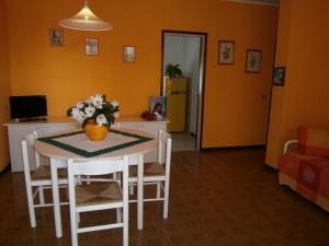 a kitchen with a table with a vase of flowers on it at Luca in Bibione