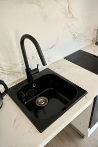 a black kitchen sink on a counter at Magnolia in Alicante