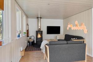 a living room with a couch and a flat screen tv at 1352-Vestervig-Isfuglevej-19 in Vestervig