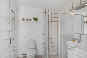 a white bathroom with a toilet and a sink at 1352-Vestervig-Isfuglevej-19 in Vestervig +18 photos