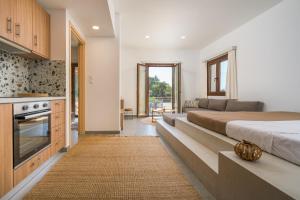 a bedroom with a large bed and a kitchen at Galma Luxury Homes in Kalymnos