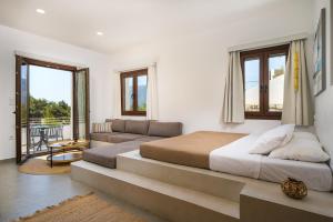 a bedroom with a large bed and a couch at Galma Luxury Homes in Kalymnos +65 photos