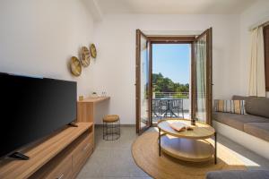a living room with a large flat screen tv at Galma Luxury Homes in Kalymnos