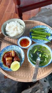 a tray of food with rice and vegetables on it at Cactos Pool & Palms Local Stay in Ho Chi Minh City