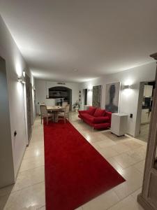 a living room with a red couch and a red rug at Dream Place in Iserlohn in Iserlohn