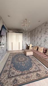 a living room with a couch and a rug at Квартира Алимжанова 16 Балхаш in Balqash