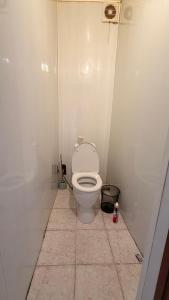 a bathroom with a white toilet in a stall at Квартира Алимжанова 16 Балхаш in Balqash +1 photo