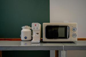 a kitchen counter with a microwave and a toaster oven at 스테이머묾 m2 in Jeonju