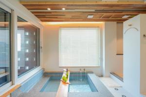 a swimming pool in a house with a window at 스테이머묾 m2 in Jeonju +10 photos