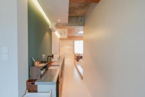 a kitchen with green walls and a long counter at 스테이머묾 m2 in Jeonju