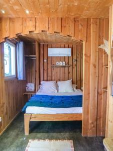 a bedroom with a bed in a wooden cabin at Lodges en Provence - Ecogîtes & Restaurant insolites in Richerenches