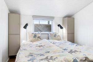 a bedroom with a bed and a window at 1369-Thisted-Nordsovej-94 in Nørre Vorupør