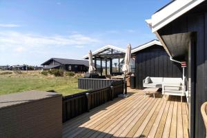 a wooden deck with a gazebo on a house at 1369-Thisted-Nordsovej-94 in Nørre Vorupør