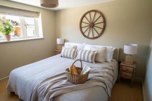 a bedroom with a bed with a basket on it at The Stable in Clack