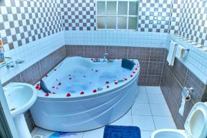 a bathroom with a tub with apples in it at Residence Next Door-5 in Nairobi