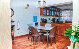 a dining room with a table and chairs in a kitchen at Residence Next Door-5 in Nairobi