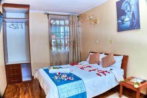 a bedroom with a large bed with flowers on it at Residence Next Door-5 in Nairobi