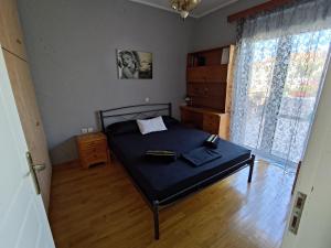 a bedroom with a bed in a room with a window at Dream Home in Sparta
