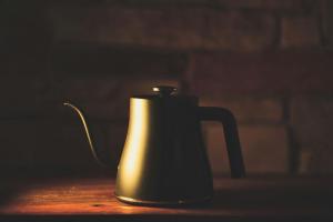 a black tea kettle sitting on a table at The Sanctuary in McLeod Ganj