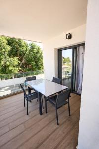 a dining room with a table and chairs on a balcony at Magnolia in Alicante