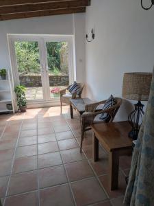a living room with a couch and a table at The Stables in Aglish