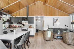 a kitchen and living room with a table and chairs at OH293-Hadsund-Jaegerskoven-15 in Hadsund