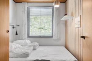 two beds in a room with a window at OH293-Hadsund-Jaegerskoven-15 in Hadsund