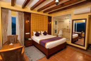 a bedroom with a bed and a bathroom at Paradise Villa in Kathmandu
