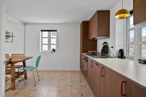 a kitchen with a table and a dining room at 1073-Thisted-Orhagevej-30 in Klitmøller
