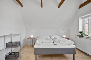 a white bedroom with a bed with white sheets at 1073-Thisted-Orhagevej-30 in Klitmøller