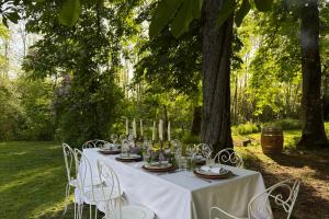 a table with a white table cloth and white chairs at La Maison 1680 in Couches +51 photos