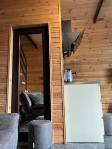 a room with a bar and a couch and a table at Barbare Cottage in Chakvi